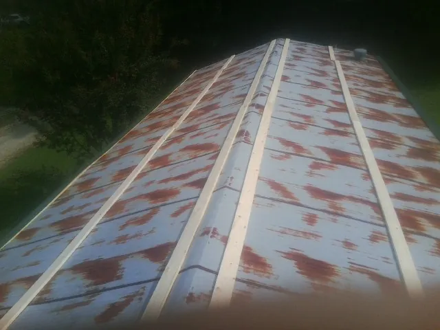 Rusted metal roof panels with new wood purlins before replacement — Storm Damage Roof Repair in Cochecton by Roofing Brothers