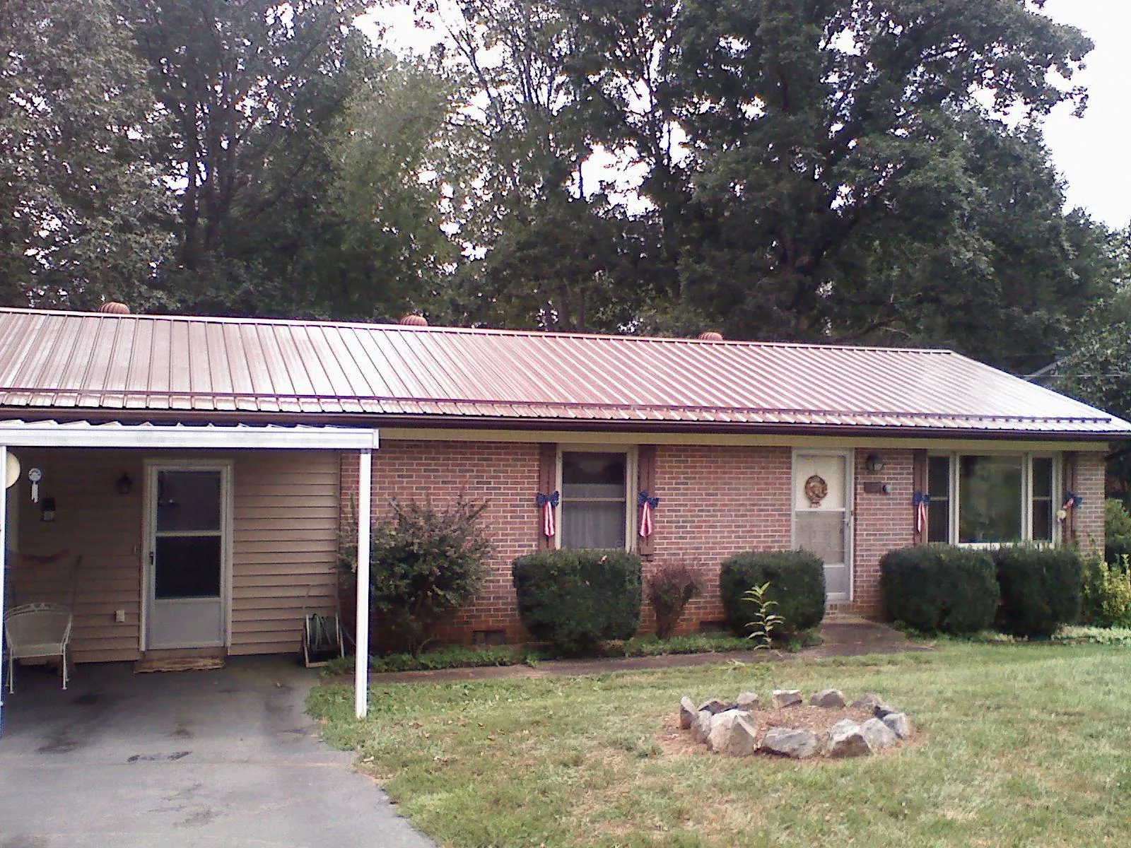 Bronze metal roof and carport on a brick ranch home — Roof Repair work by our crew in Cochecton